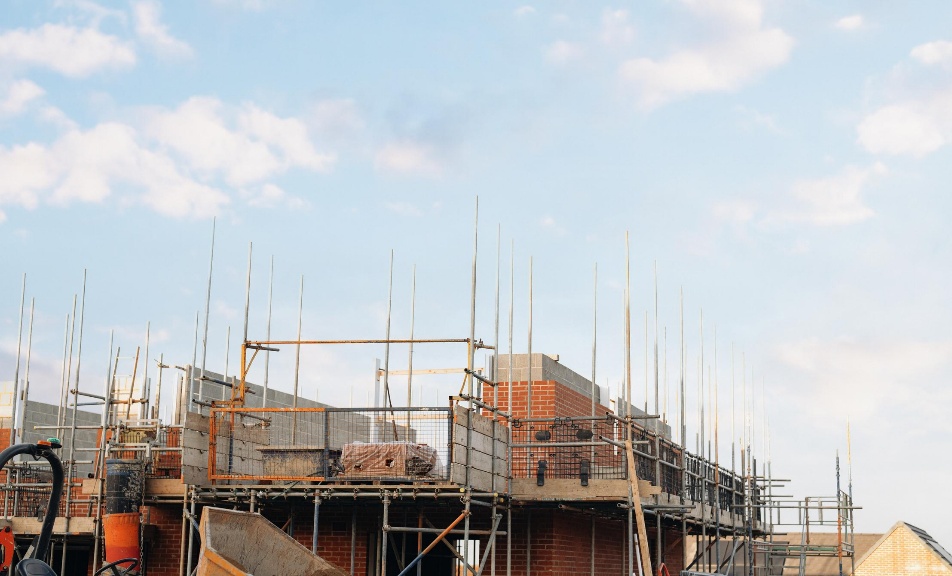 Construction team with hard hats reviewing project paperwork on site